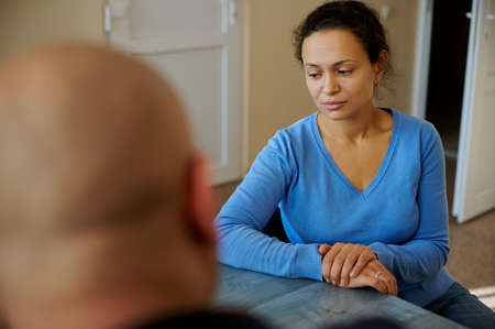The doctor's consultation. The portrait of a patient sitting in front of the doctor, during the diagnosis.の写真素材