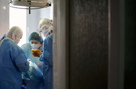 Surgery. Operation is in progress. View from behind the operating room door.の写真素材