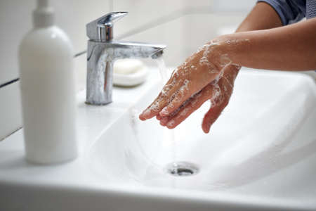 Hand washing rubbing the back of the hands. Prevention of viral and bacterial infections. Fighting coronavirus epidemic.の写真素材
