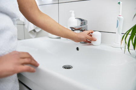 A roll-on antiperspirant on the washsbasin.