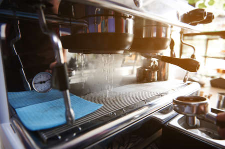 Starting a professional steam coffee machine. Preparing the coffee machine for brewing coffee Starting a professional steam coffee machineの写真素材