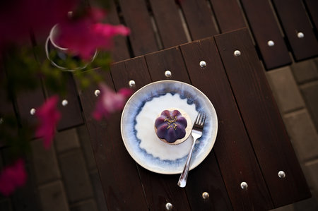 High angle view of a delicious handmade raw vegan dessert served on a plate on wooden table. Food backgroundの写真素材