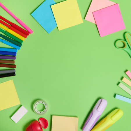 Flat lay composition with stationery office or school supplies scattered in a circle on a light green background with copy space. Teacher's day conceptの写真素材