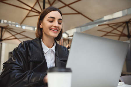 Confident young business woman, copywriter, developer, freelancer, journalist working remotely on...