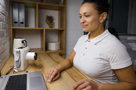 African American confident woman, middle aged female doctor dentist giving online consultation,...