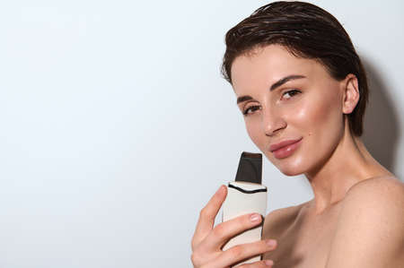 Ultrasound cosmetology scrubber. Face cavitation procedure. Salon skincare treatment. Professional...