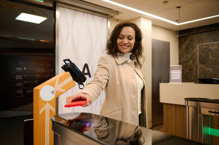 Business woman passenger scanning information on the phone by placing it over the scanner to read...