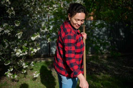 Delightful middle aged female gardener, pleasant housewife working in the gardenの写真素材