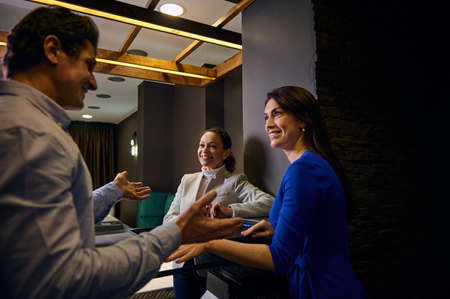A Caucasian couple shopping for new furniture, talking with a retail consultant in home design studioの写真素材