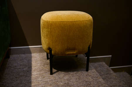Stylish velour yellow footstool, ottoman in the furniture design showroomの写真素材