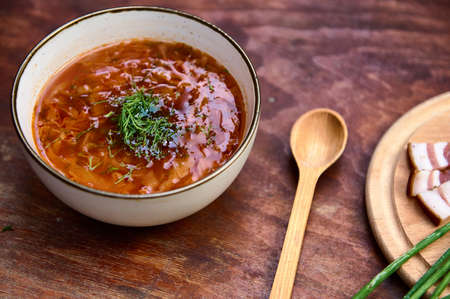 National Ukrainian cuisine. Red beetroot soup- Traditional Ukrainian Borscht served in bowl with...