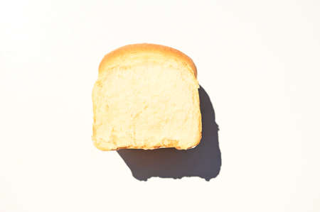 Loaf of freshly baked whole grain bread isolated on white background with copy space for advertising text. Flat layの写真素材
