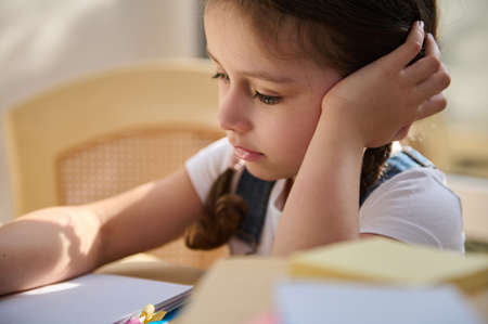 Close-up portrait of a beautiful little girl, schoolgirl, pupil in primary school, first grader...