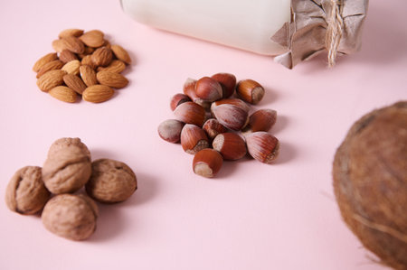 Selective focus on organic hazelnuts nearby assortment of wholesome almond nuts, walnuts, coconut...
