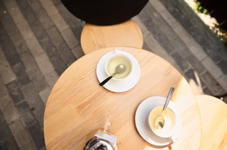 View from above of teacups with healthy antioxidant herbal drink on a round wooden table. Copy space. Food and drink consumerismの写真素材