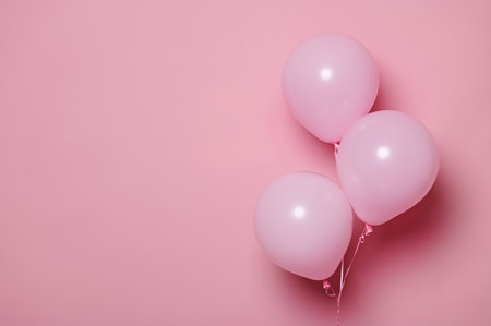 Three pink pastel inflatable air balls, helium balloons on isolated pink color background with free advertising space. Beautiful decoration for celebrating events. Birthday. Anniversary. Mockupの写真素材