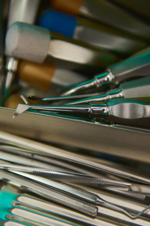 Selective focus. Closeup professional stainless steel dental instruments and accessories inside an...