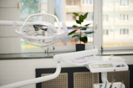 Dental office interior. Dental equipment. Operating surgical lamp with directional LED light in modern dentistry clinic. Dental practice. Dentistry. Healthcare and medicineの写真素材