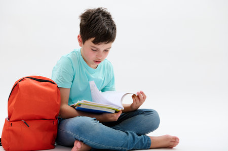 Caucasian confident smart primary school student, teenager boy 11-13 years old, wearing a blue...