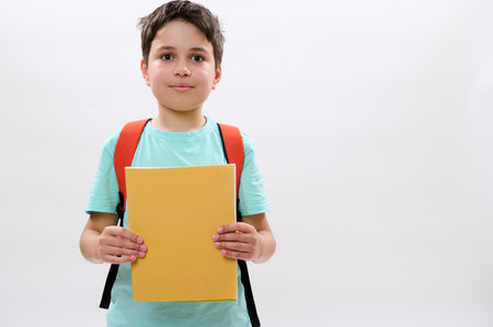 Confident portrait of a Caucasian teenager boy, happy handsome school child 11-13 years old with...