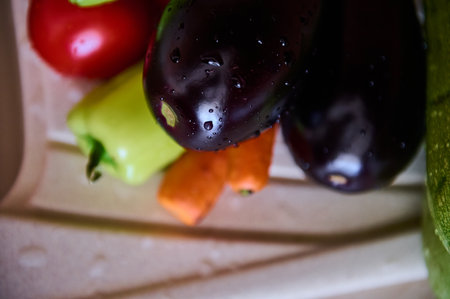 Selective focus on fresh ripe organic vegetables with drops of water in the kitchen sink. Crop of veggies. Nourishment. Ingredients. Nutrition. Healthy vegetarian diet. Food background. Top viewの写真素材