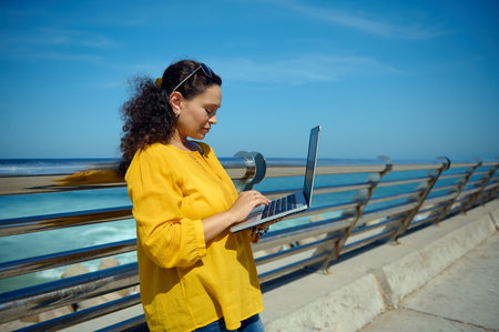 Side portrait of a middle aged multitasking confident female entrepreneur, businesswoman dressed in...