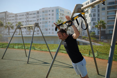Working hard. Side view of determined Caucasian young athletic man with perfect body in sportswear,...