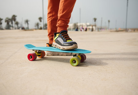 Skateboarding legs. Close-up teenager legs on skateboard, skateboarding on a skatepark playground outdoors. People. Lifestyle. Leisure activity. Kids entertainment concept. Extreme sport. Childhoodの写真素材