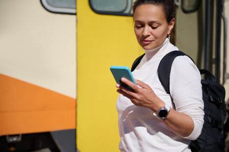 Caucasian young pretty woman passenger, a tourist traveler checking mobile app on her smartphone,...