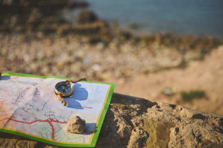 Finding your way with compass and map on the top of the rock overlooking the Atlantic ocean. Still...