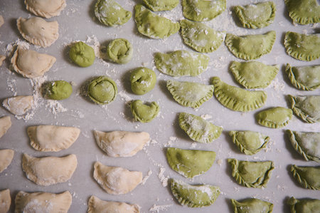 View from above. Food background with molded raw dumplings. Varennyky and ravioli on a floured marble surface of kitchen table. Ukrainian traditional cuisine. Food. Traditions and cultureの写真素材