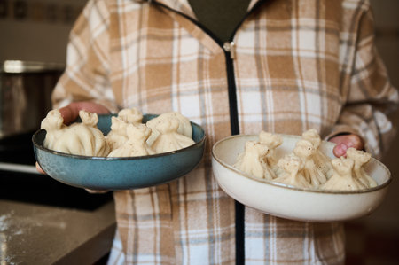 Homemade Georgian khinkali served in bowls, prepared fresh in a warm and inviting kitchen.