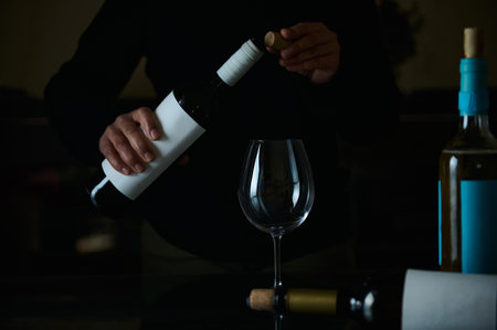 Wine being uncorked in preparation for serving, showcasing a sophisticated and thoughtful lifestyle moment.の写真素材