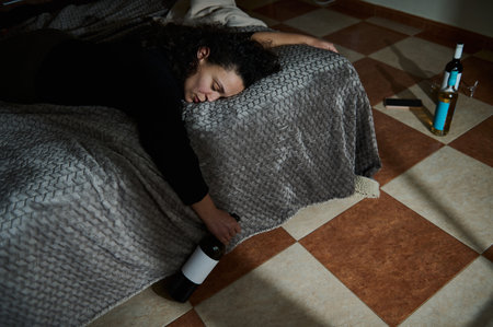 A person resting on the floor with a blanket, creating a scene of solitude and contemplation.の写真素材