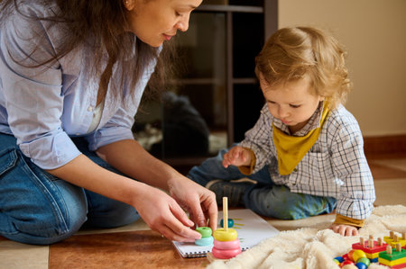 A mother and child learning with creativity, promoting intellectual growth and bonding through...