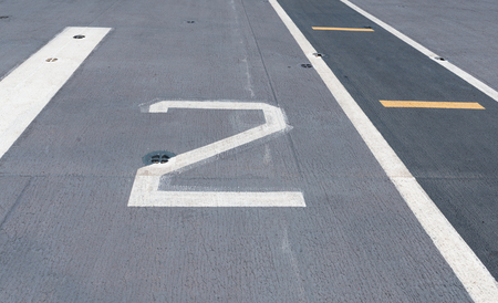 Number " 2 " on white . Takeoff runway and runway aircraft carrier on battleship. Public area.の写真素材