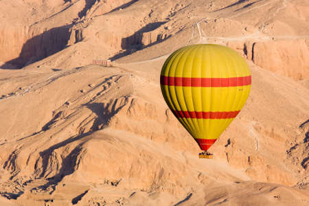 Hot air balloon flying over the Valley of the Kings, Egyptの写真素材