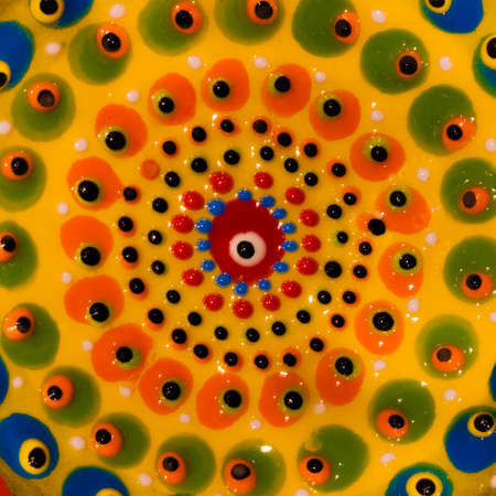 Close up of a colourful ceramic bowl from Greece, with a repeating "Evil Eye" designの写真素材