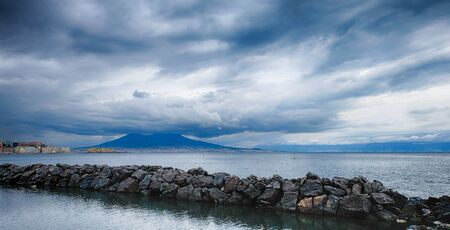 Cloudy day, Naples cityscape and Vesuvius from the Mergellina sea. Italyの写真素材