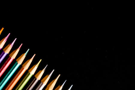Set beautiful black, colored pencils of colored pencils on black background. Soon to school. Back to Schoolの写真素材