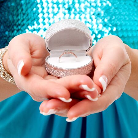 Hands with ring in box