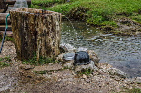 Washing dishes.Camping cooking gear.Dirty plates and dishes on a campsite waiting to be washed up.Apuseni Mountains in Romania.Natural background.の写真素材