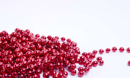 Red Christmas decorative beads on a light background の写真素材