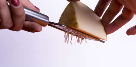 Gratis with cheese grater. white background, women's handsの写真素材
