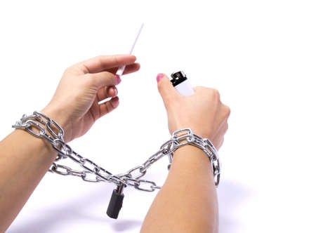 Hands chained cigarette passionately fighting white backgroundの写真素材