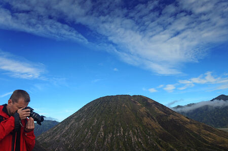 A tourist photographing near Mount Batok, bromo area, East Java, Indonesiaのeditorial素材
