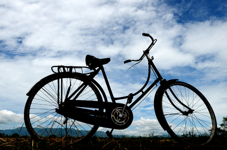 Ancient bicycle silhouette against the background of rice fields in Ponorogo, East Java, Indonesiaの写真素材