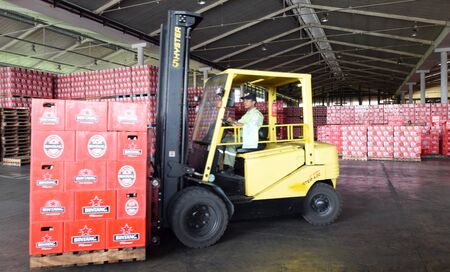 Mojokerto East Java Indonesia  April 9 2015: Workers transporting bottled beer star in beverage production in Trawas Mojokerto East Java. Indonesia has banned small retailers from selling beer despite an outcry from the booze industry and in tourism hotspのeditorial素材