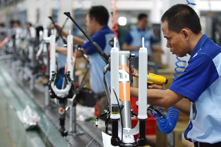 Workers check on the assembly line at the assembly bicycle bike from Indonesia Polygon in Sidoarjo East Java Indonesia thursday April 9 2015.のeditorial素材