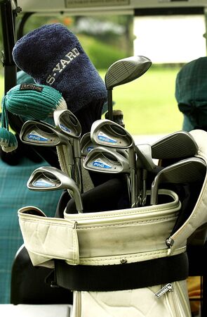 Golf club Bag with golf clubs Green golf field and ball in grassのeditorial素材